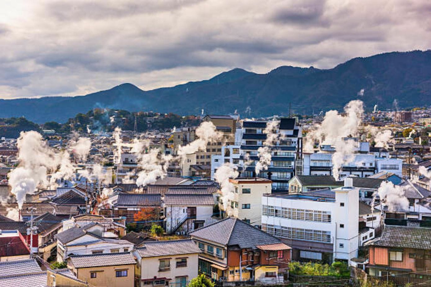City view of Beppu Onsen with steam rising from the rooftops