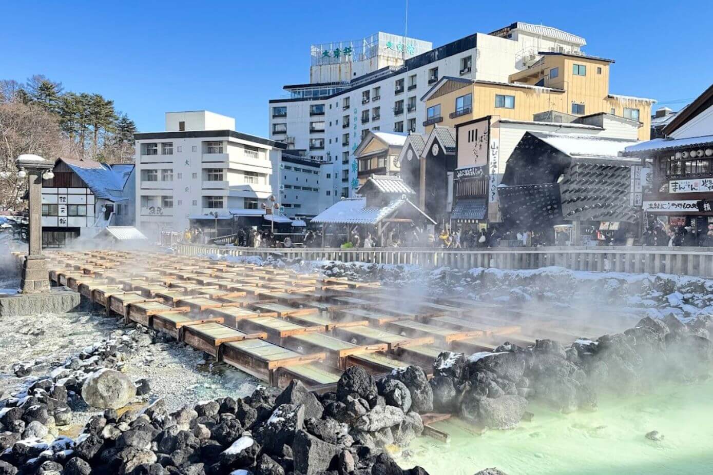 Yubatake - steaming wooden structure where the mineral-rich
									waters are cooled in Kusatsu Onsen